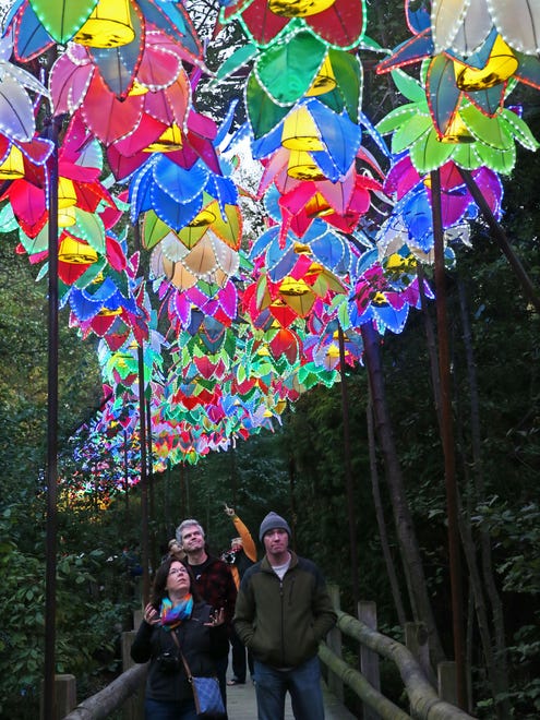 Lanterns illuminates the people walking at the China Lights display at Boerner Botanical Gardens.