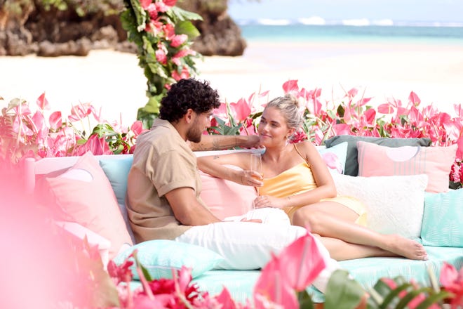 Wisconsin native Carmen Kocourek shares a moment on her final date with Kenzo Nudo during the season finale of "Love Island USA" in summer 2023. They had a romantic setting at the beach surrounded by pink-petaled flowers shaped in the form of a heat.
