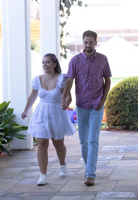 Wisconsin native Grace Girard and farmer Brandon Rogers walk off to their date during the third episode of "Farmer Wants a Wife." Rogers called her "calm" during a chaotic day with his fellow singles vying for his heart