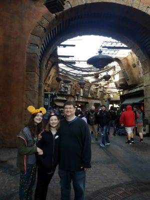 Alex, Wendy and Jonathan Schwabe spend time at Galaxy's Edge, a Star Wars-themed land in Disney World, in February 2020.